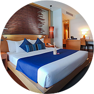 Prana hotel room with a blue comforter and nice furniture in Koh Samui